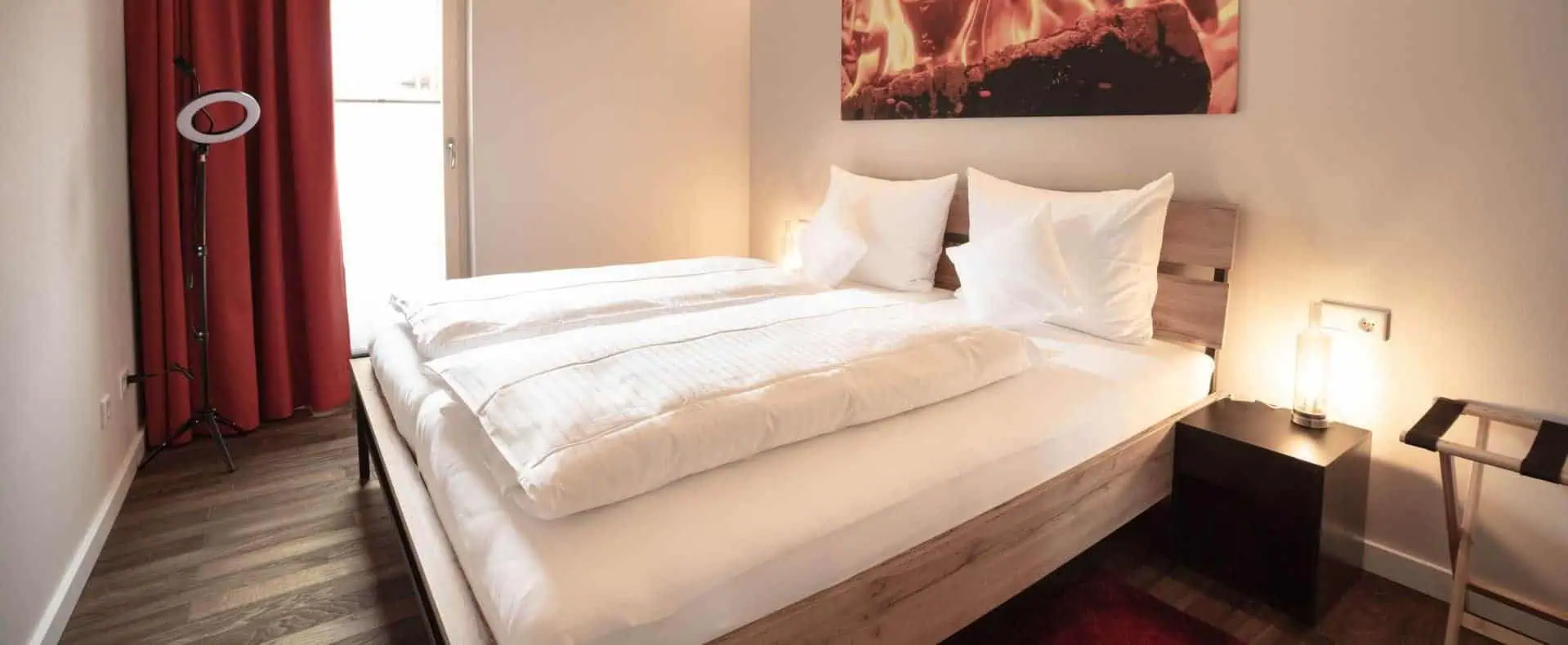 Schlafzimmer mit Doppelbett und Ausgang auf den Balkon
